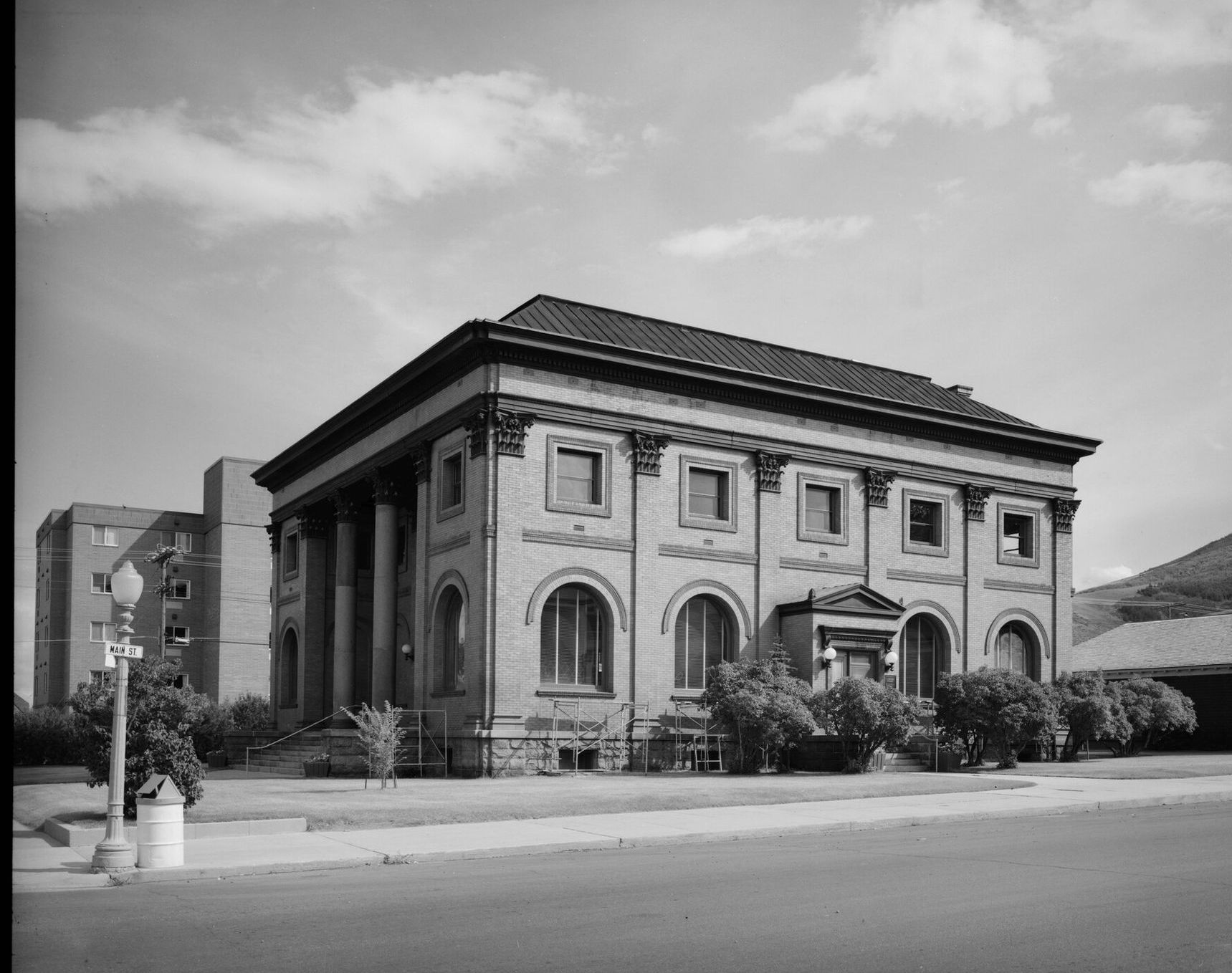 The Hearst Free Library, a two-story classical brick building with columns, on a street corner