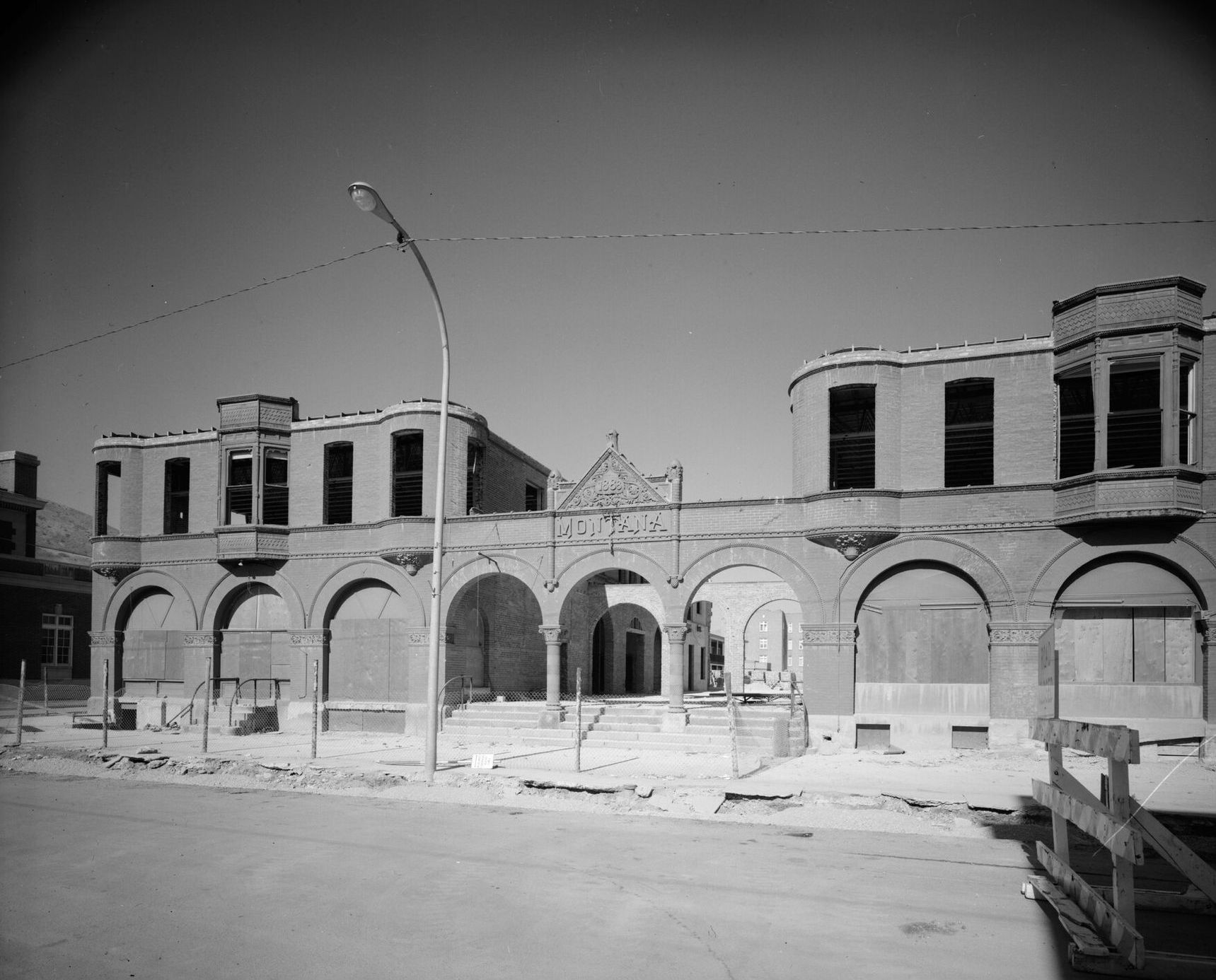 Brick arcade and bay windows of the Montana Hotel on an Anaconda street corner