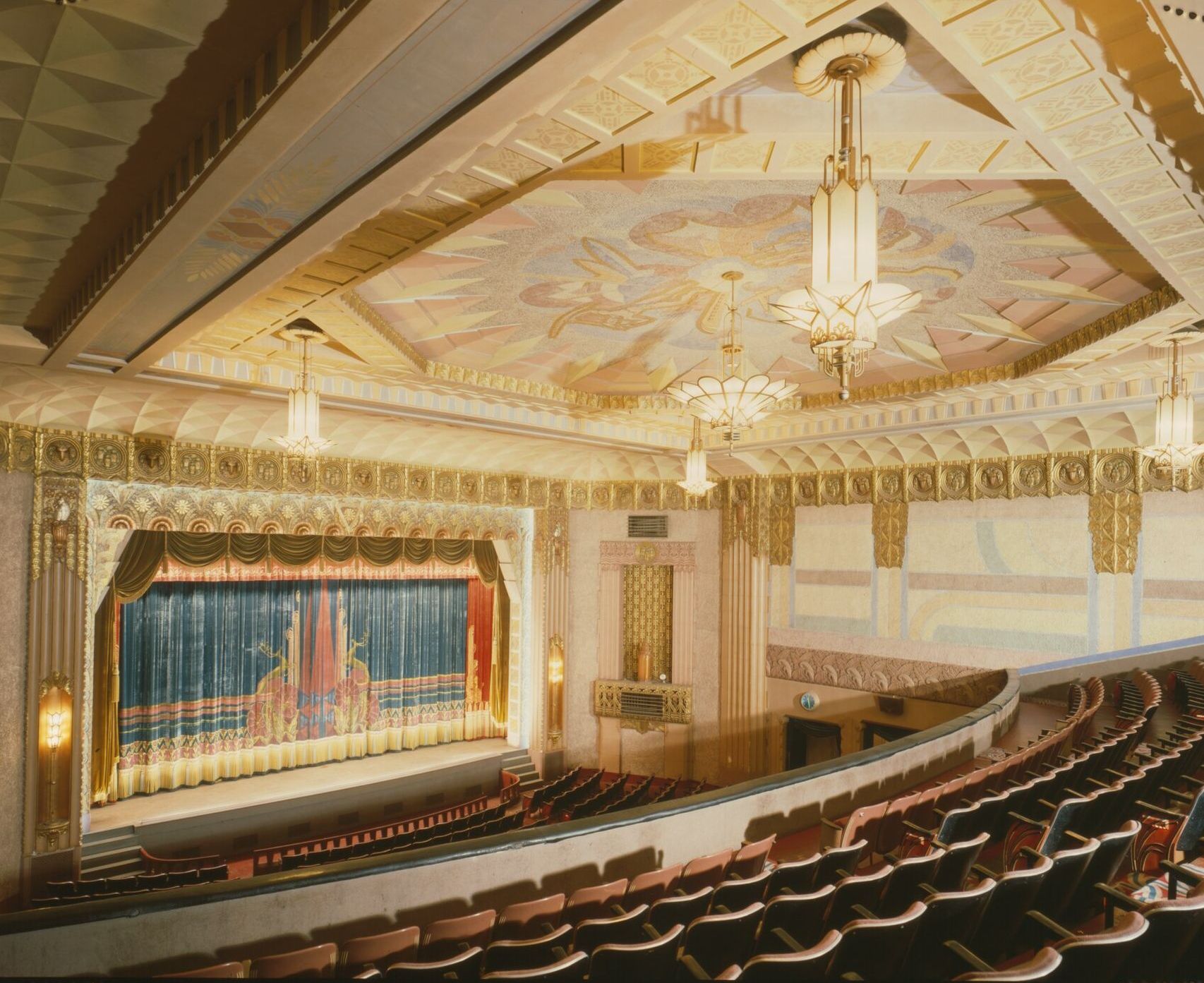 Interior of the Washoe Theater from the balcony: gilded proscenium, painted ceiling and rows of seats